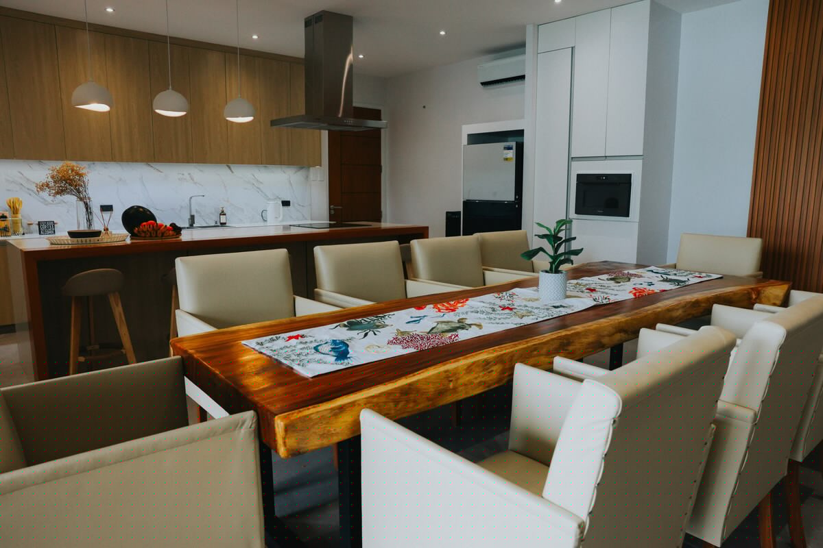 Gourmet kitchen with live-edge dining table and pendant lights